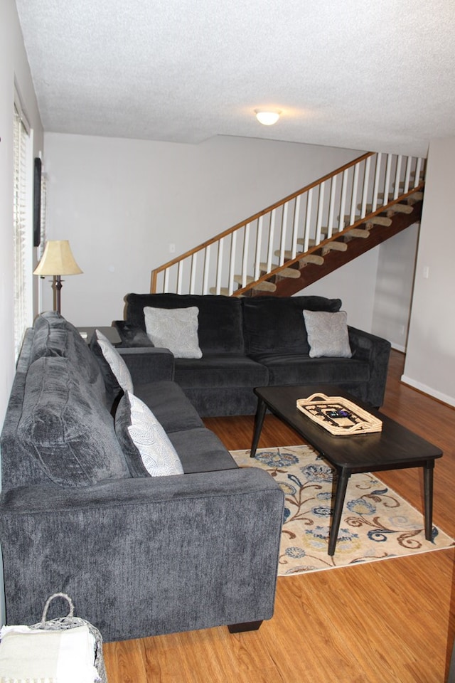 101F Country Club Dr, Americus, GA 31709 - living room with stairs, a textured ceiling, wood finished floors, and lofted ceiling