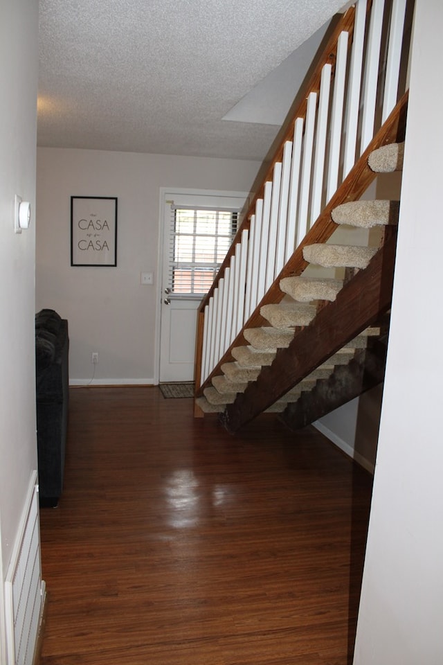 101F Country Club Dr, Americus, GA 31709 - foyer with a textured ceiling, wood finished floors, baseboards, and stairs