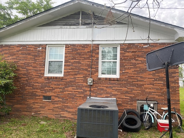 view of side of home featuring central AC unit