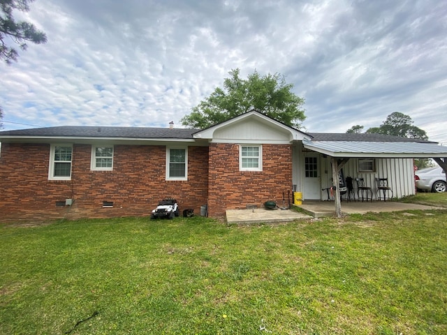 rear view of house with a yard and a patio