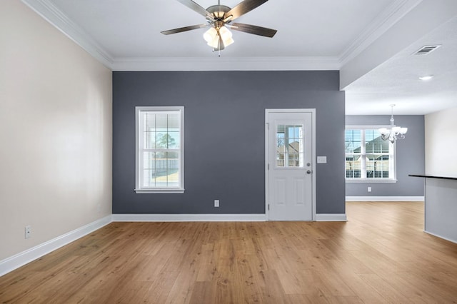 foyer entrance with light wood-type flooring, ceiling fan with notable chandelier, and crown molding