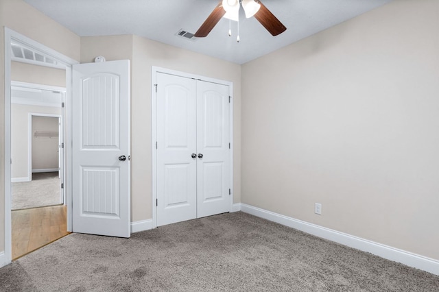 unfurnished bedroom with ceiling fan, a closet, and light carpet