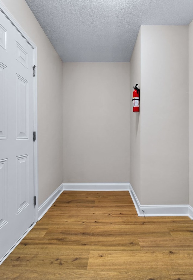 spare room featuring hardwood / wood-style flooring and a textured ceiling