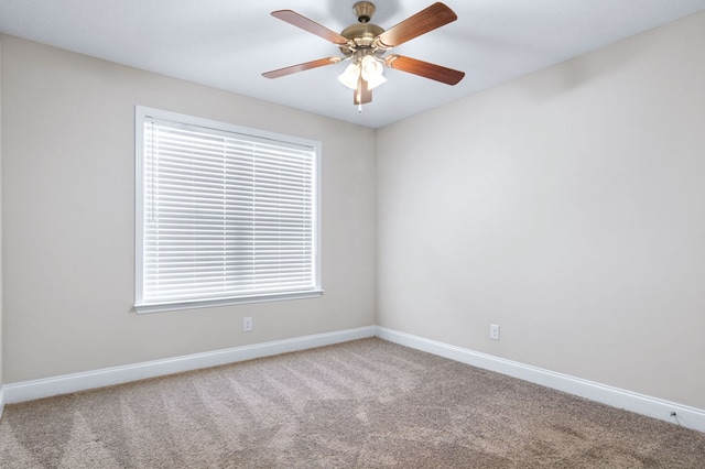 empty room featuring ceiling fan, a wealth of natural light, and carpet floors