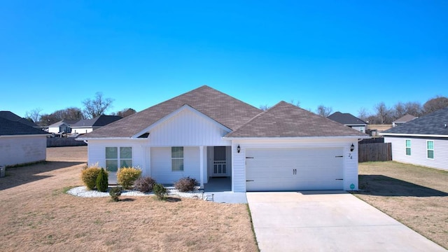 ranch-style home featuring a garage and a front yard