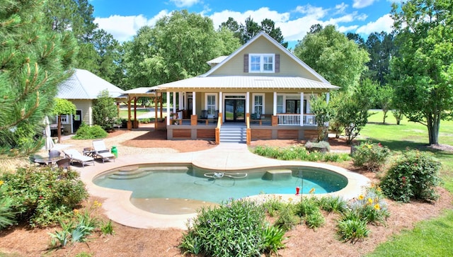 back of property featuring a patio and covered porch