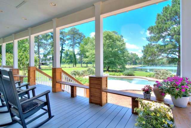 wooden terrace featuring a water view