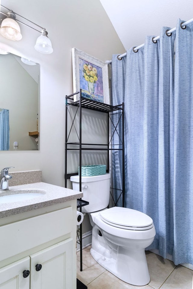 bathroom featuring tile patterned flooring, vanity, and toilet