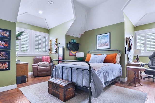 bedroom featuring lofted ceiling and hardwood / wood-style floors