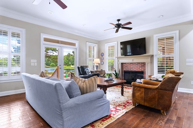 living room featuring dark hardwood / wood-style flooring, ornamental molding, french doors, and ceiling fan