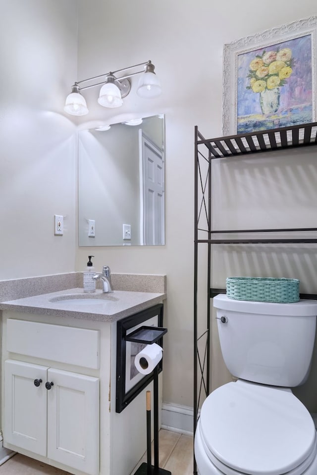 bathroom with vanity, tile patterned floors, and toilet