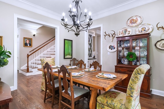 dining area with crown molding, dark wood-type flooring, and an inviting chandelier