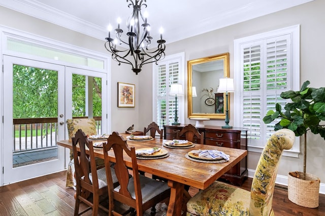 dining area featuring ornamental molding, dark wood-type flooring, a chandelier, and french doors