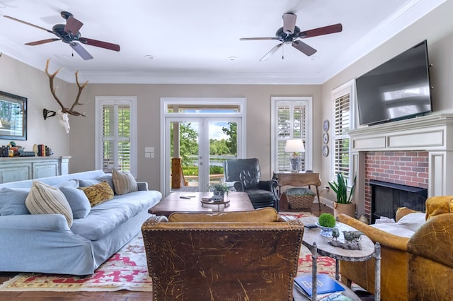 living room with a fireplace, a wealth of natural light, ornamental molding, and french doors