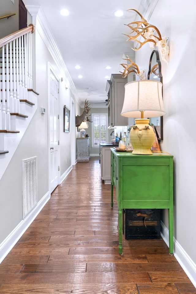 interior space featuring crown molding and dark hardwood / wood-style floors