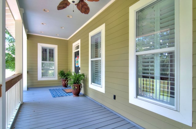 deck with ceiling fan and a porch