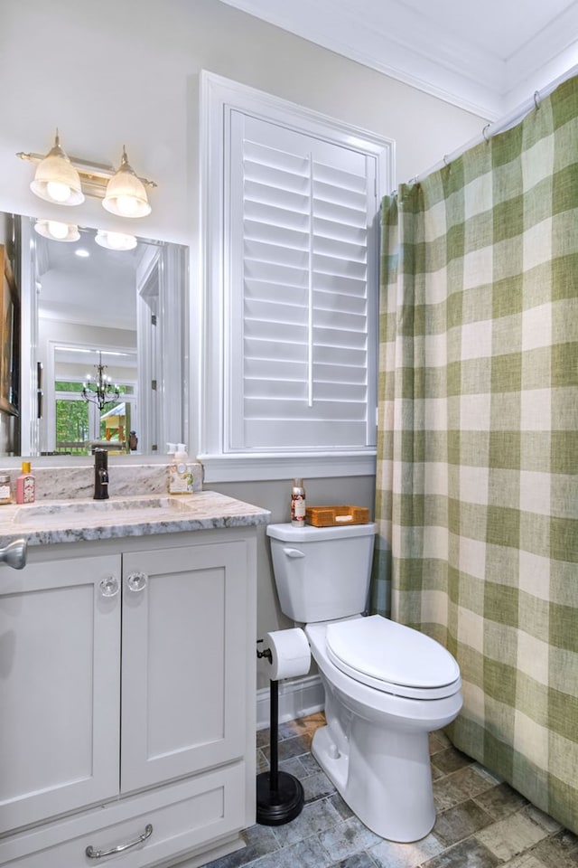 bathroom featuring ornamental molding, toilet, and vanity