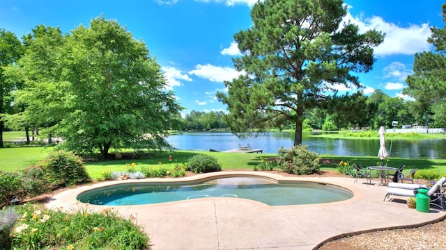 view of swimming pool featuring a yard, a patio area, and a water view