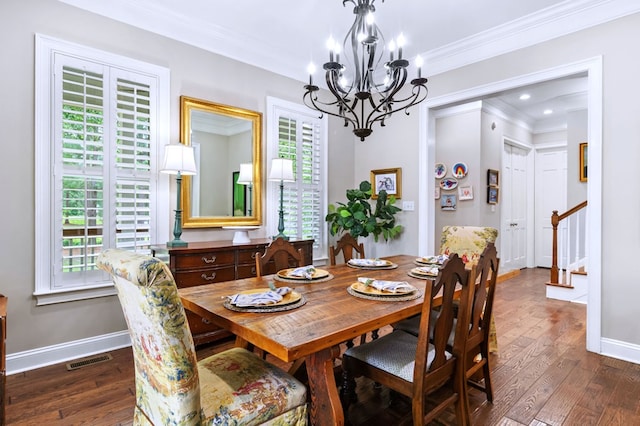 dining room with a notable chandelier, ornamental molding, and dark hardwood / wood-style floors