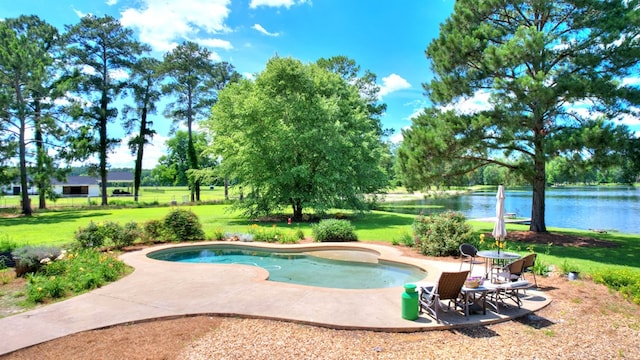 view of swimming pool featuring a water view, a patio area, and a lawn