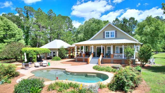 rear view of property featuring a patio area