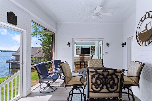 sunroom / solarium with wooden ceiling, a water view, and a ceiling fan