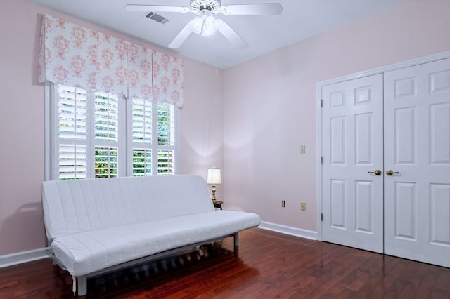 sitting room featuring baseboards, visible vents, ceiling fan, and dark wood-type flooring