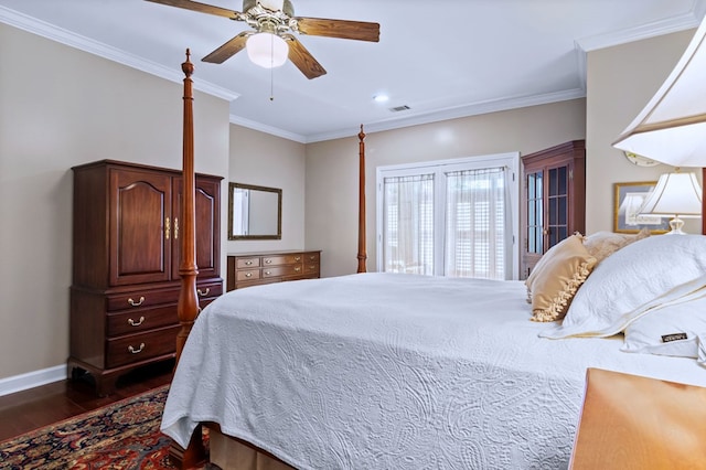 bedroom featuring dark wood-style floors, visible vents, ornamental molding, and baseboards