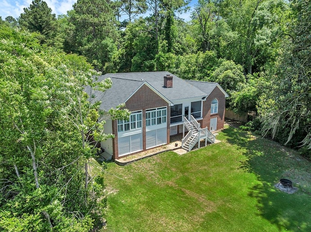 190 Scenic Rt, Cordele, GA 31015 - view of front of property with a sunroom, stairs, brick siding, a view of trees, and roof with shingles