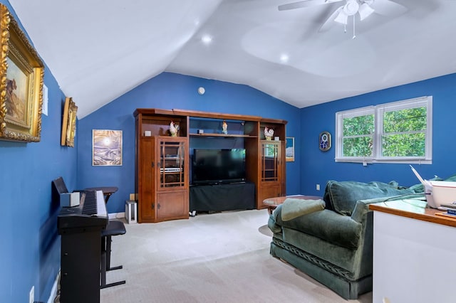 living area with light carpet, ceiling fan, and lofted ceiling