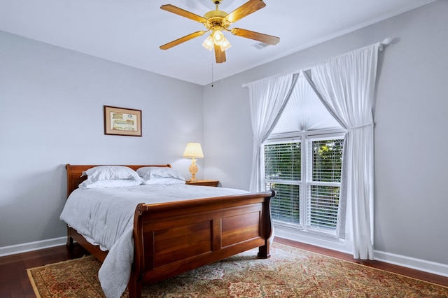 bedroom featuring dark wood finished floors, baseboards, and ceiling fan