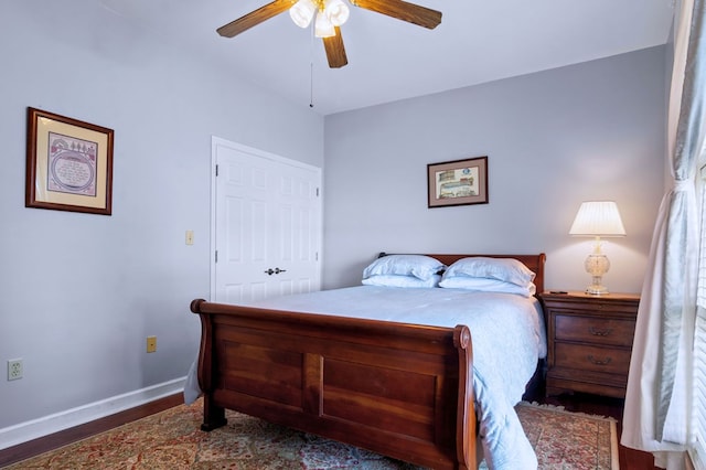 bedroom featuring ceiling fan, baseboards, and dark wood finished floors