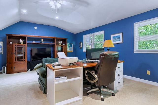 office area featuring lofted ceiling, a healthy amount of sunlight, and light colored carpet