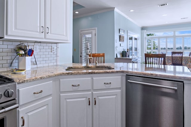 kitchen with stainless steel appliances, white cabinets, crown molding, and visible vents