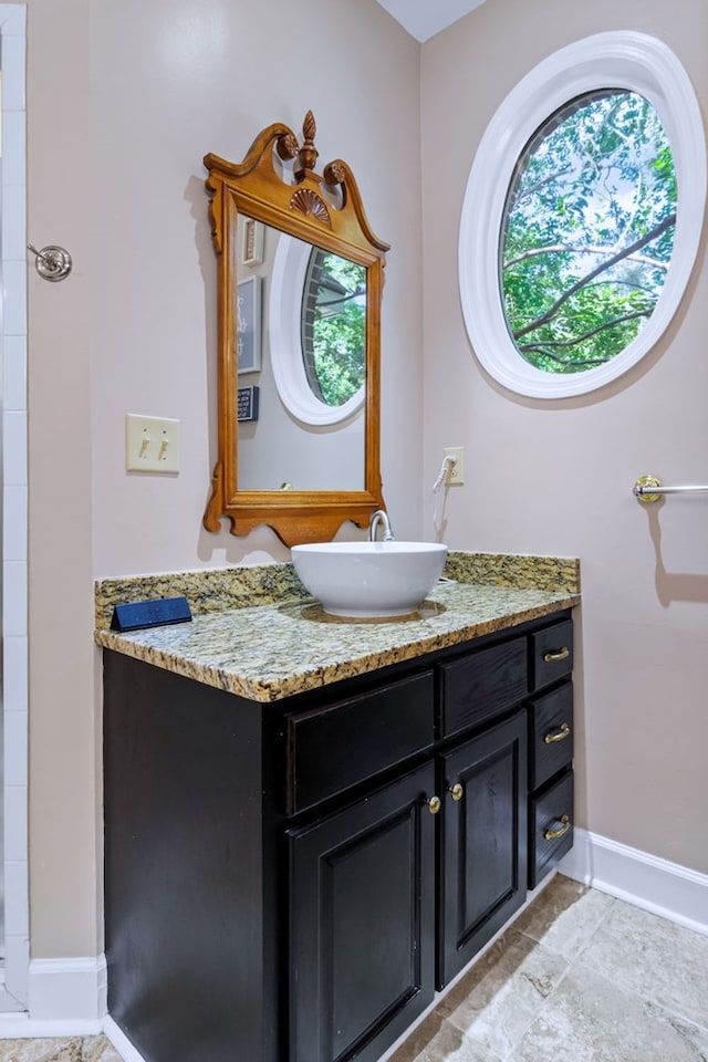 bathroom with vanity and baseboards