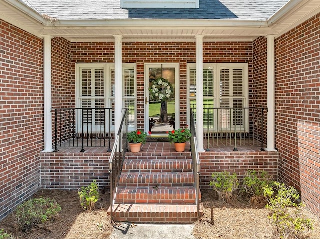 190 Scenic Rt, Cordele, GA 31015 - view of exterior entry with covered porch, roof with shingles, and brick siding