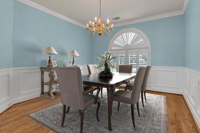 190 Scenic Rt, Cordele, GA 31015 - dining space featuring a chandelier, crown molding, wood finished floors, wainscoting, and a decorative wall