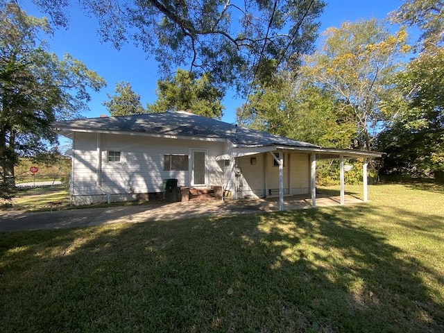 back of property featuring a lawn