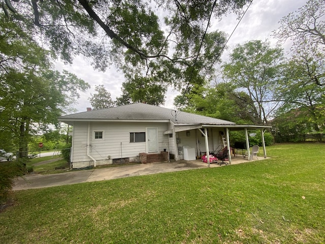 back of house featuring a patio area and a lawn