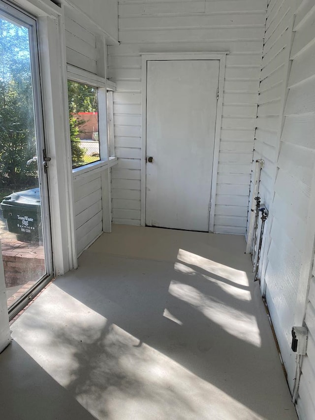 interior space with wooden walls and concrete floors