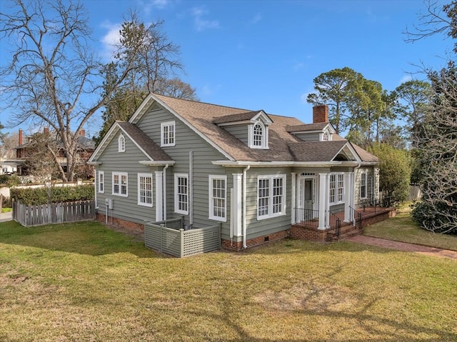 back of property featuring crawl space, a chimney, fence, and a yard