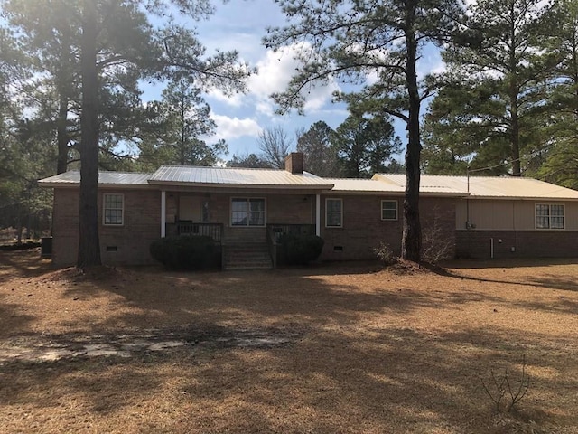 rear view of property with covered porch