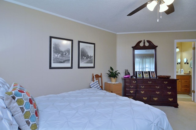 carpeted bedroom with ceiling fan, ensuite bathroom, crown molding, and a textured ceiling