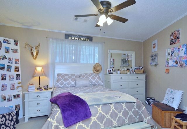 carpeted bedroom with ceiling fan, a textured ceiling, fridge, and crown molding