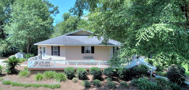 view of front facade with a deck and a storage unit