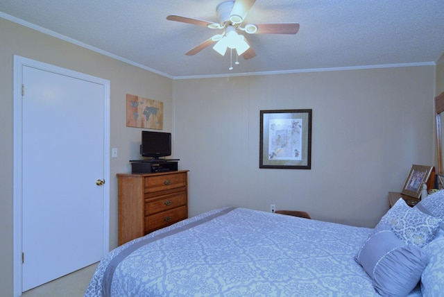 bedroom with ceiling fan, ornamental molding, and a textured ceiling