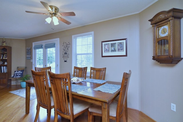 dining space featuring light wood-type flooring, ceiling fan, and ornamental molding