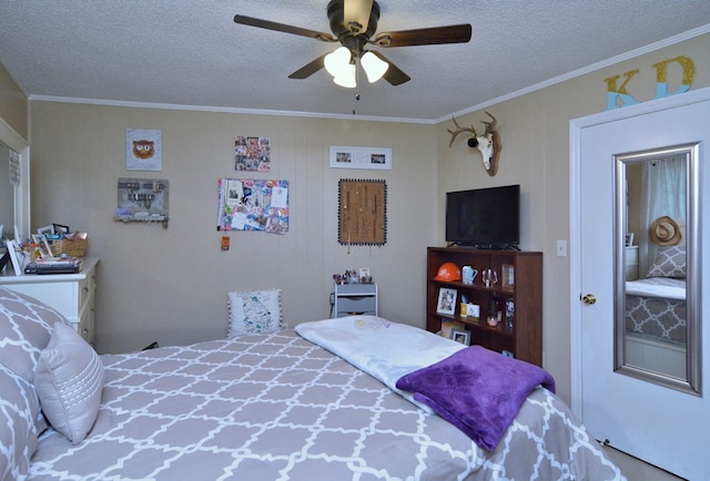 bedroom featuring ceiling fan, a textured ceiling, wood walls, and crown molding