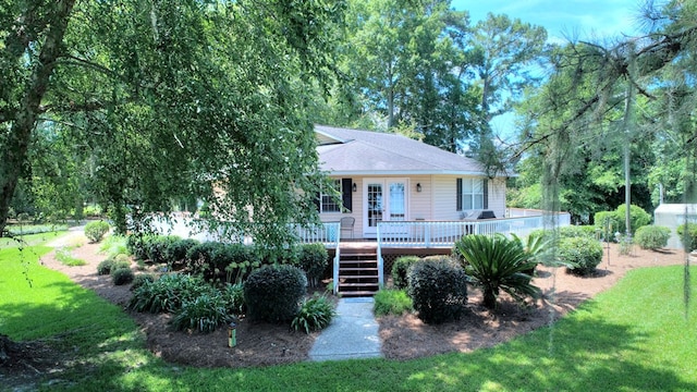 view of front of home featuring a front lawn and a deck