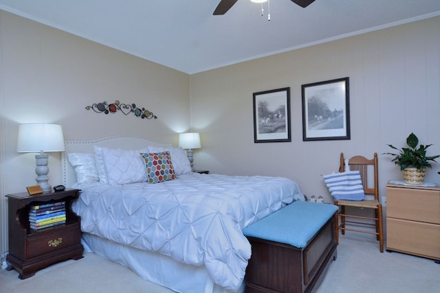 carpeted bedroom featuring ceiling fan and crown molding